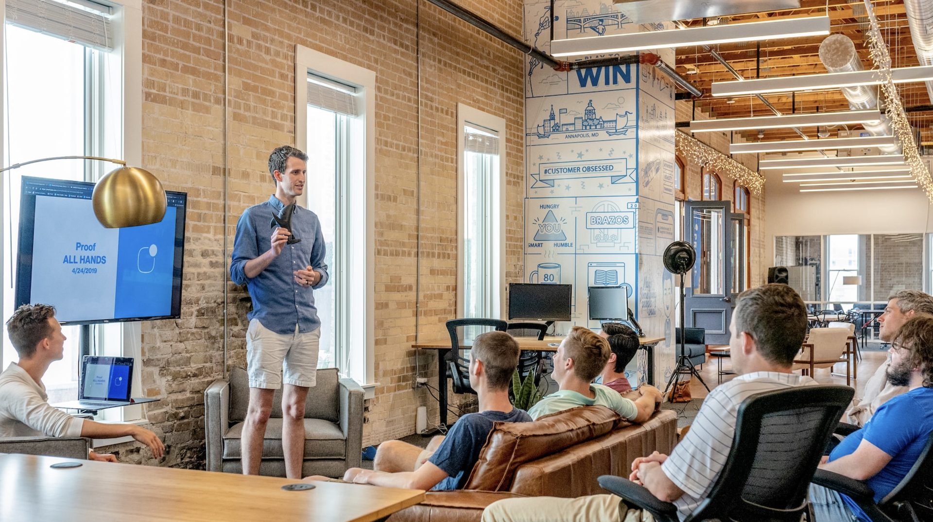 A presenter leading a team meeting in a modern office